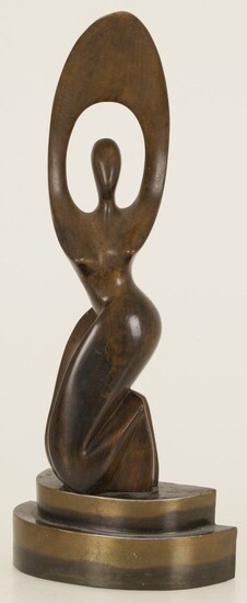 A carved wooden sculpture of a kneeling dancer mounted on a brass base, 20th century....