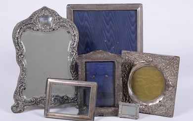 A collection of silver mounted photo frames and a silver mounted mirror