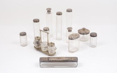 A collection of silver topped glass vanity jars, comprising a...