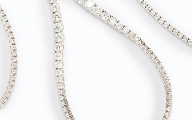 A diamond and fourteen karat white gold necklace