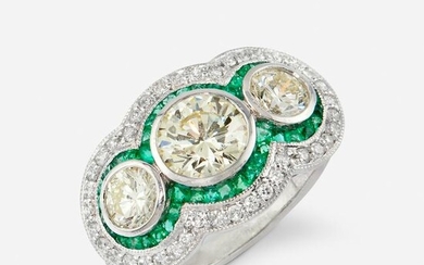 A diamond, emerald, and platinum ring