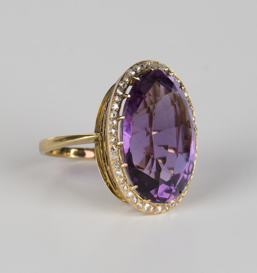 A gold, amethyst and rose cut diamond oval cluster ring, claw set with the oval cut amethyst within