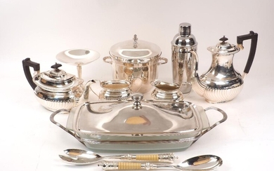 A group of silver plate including: a small novelty flute; an ice bucket, a cocktail shaker, a four piece tea set; a serving dish with glass liner, a tazza, four square trinket boxes with lids and personalised engraving; two small novelty watering...