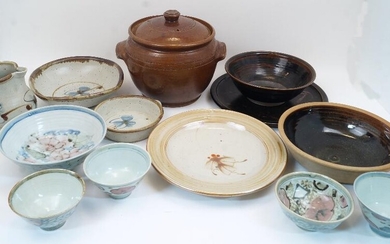 A group of studio pottery, 20th century, to include Tim Andrews bowls and jug with blue flower on buff ground, a Winchcombe Pottery bowl with dark brown glaze to the well, unglazed exterior, 26.7cm diameter, lustre glazed bowls and dishes, a large...