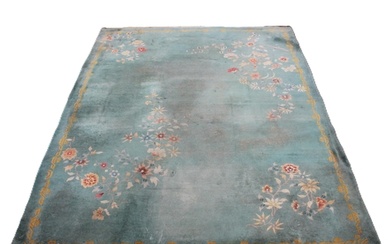 A large Chinese wool carpet, early 20th century, with floral...