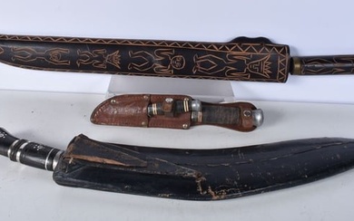 A large Indian Kukri with leather sheath together with a large South American knife with a carved wo