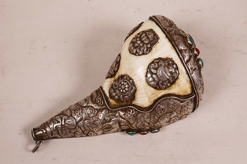 A large Tibetan white metal mounted conch shell, with repous...