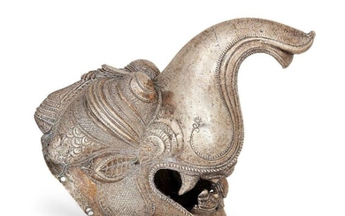 A large silver palanquin pole finial with Makara head, South India, circa 1800, the mythical creature depicted with open mouth bearing fangs, raised trunk and bulging eyes, 17cm high x 10.7cm diam x 22.6cm Provenance: Simon Ray Indian and Islamic...