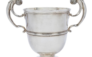 A late Victorian twin handled cup, London, 1899, Charles Stuart Harris, with bifurcated scroll handles and reeded band to body, raised on a stepped circular foot, 24cm high (inc. handles) approx. weight 39oz