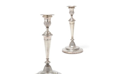 A pair of George III silver circular candlesticks by John Green, Roberts, Mosley & Co.