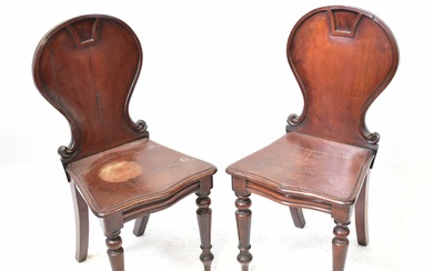 A pair of Regency mahogany hall chairs with balloon backs,...