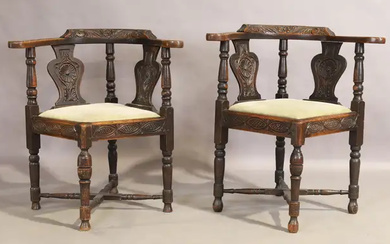 A pair of Victorian carved oak corner chairs, second quarter 19th century,...