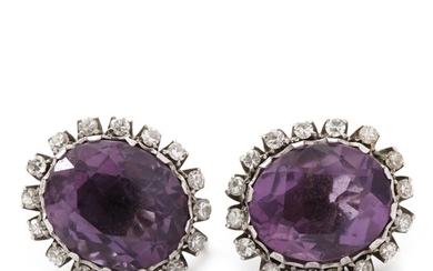 A pair of amethyst and diamond ear screws set with faceted amethysts encircled by numerous single-cut diamonds, mounted in 18k white gold. L. 1.6 cm. (2)