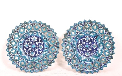 A pair of ceramic earthenware tin glazed Islamic pierced cha...