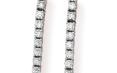 A pair of ear pendants each set with numerous brilliant-cut diamonds weighing...