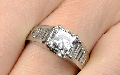 A square-shape diamond single-stone ring, with triangular-shape and baguette-cut diamond shoulders.
