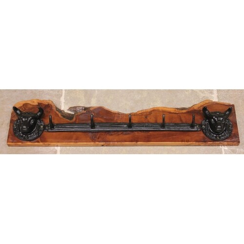 * A wall mounted cast iron and yew wood hat/coat rack, the r...