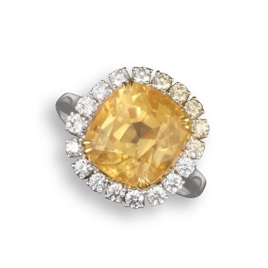 A yellow sapphire and diamond cluster ring, the...