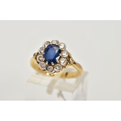 AN 18CT GOLD SAPPHIRE AND DIAMOND CLUSTER RING, centring on ...