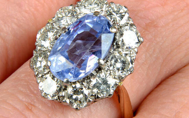 An 18ct gold Sri Lankan sapphire and brilliant-cut diamond cluster ring.