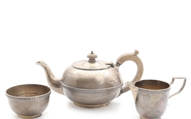 An English sterling silver teapot, sugar bowl and creamer. Manufactured by The Goldsmiths & Silversmiths Co. Ltd. and Naylor Brothers, London 1937. (3)