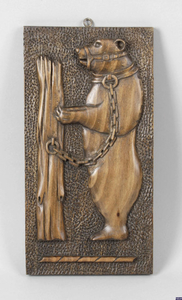 An articulated carved wall hanging dancing bear, together with a Black Forest style carved wall plaque.