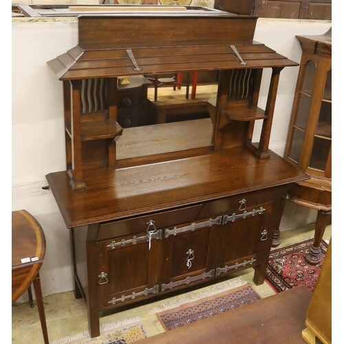 An early 20th century Arts & Crafts oak and polished steel m...