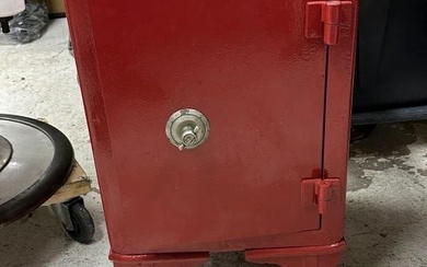 Antique cast iron small safe ( painted red ), was used in family game room as decorative object