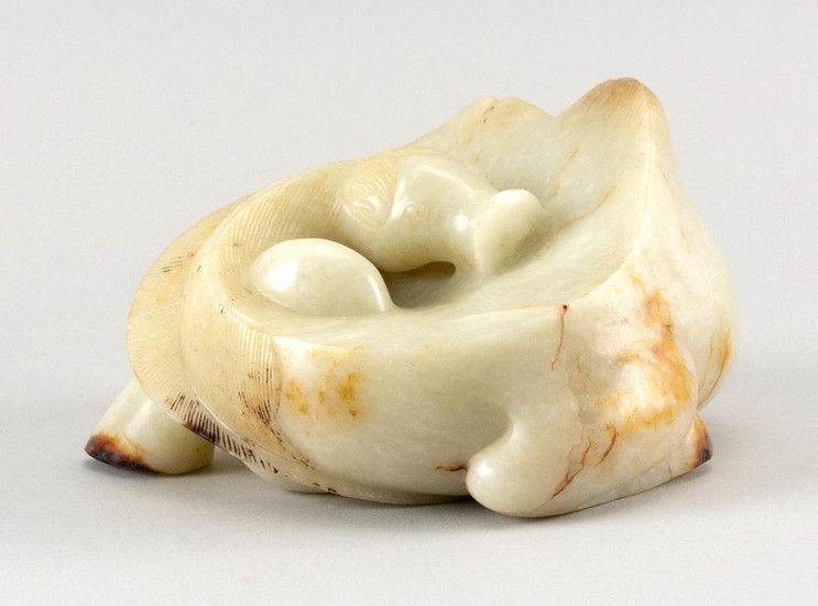 CHINESE CARVED WHITE AND RUSSET JADE CARVING OF A RECLINING CAMEL Fine integration of russet skin tones. Height 3.5". Length 5". Ex-...