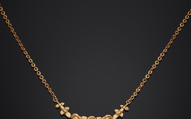 Collier en métal doré, collerette parée d’un motif ciselé de fleurs en pampille une perle...