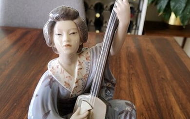 SOLD. Jens Peter Dahl-Jensen: "Geisha playing instrument". Porcelain figure decorated in colours. 1155. Dahl-Jensen. H....