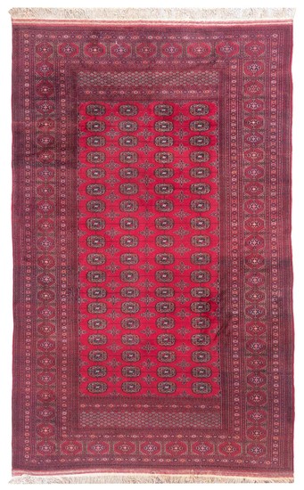 ORIENTAL RUG: BOUKARA DESIGN 6'6" x 10'0" Rich red field with four columns of red, black, pale orange and ivory tekke guls. Traditio.