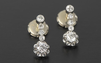 Pair of earrings in 950 thousandths platinum and 18k white gold, holding a diamond, antique cut of about 0.1ct, accompanied by four small diamonds in a closed setting.