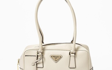 Prada: A "Bauletto" bag of beige Saffiano leather with gold tone hardware, two handles and one zipped compartment. – Bruun Rasmussen Auctioneers of Fine Art