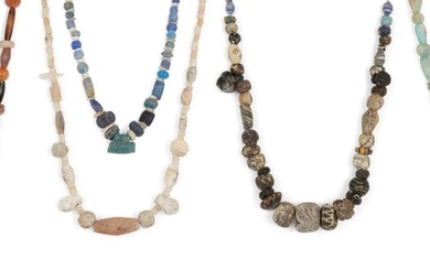 Seven strings of hardstone, glass, calcite and glazed faience beads Circa 1st Millennium B.C. – Islamic, some modern Including a string of calcite and white stone beads of spherical, cylindrical and barrel beads; three strings with glass beads...