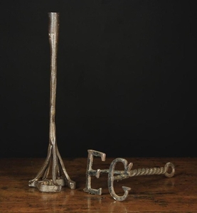 Two 18th/Early 19th Century Wrought Branding Irons; one with a candle socket on square section stem above conjoined initials HR, 16 ins (40 cm) in height. The other with initials EG on a twisted twin bine stem with lopped end, 11 ins (28 cm) in