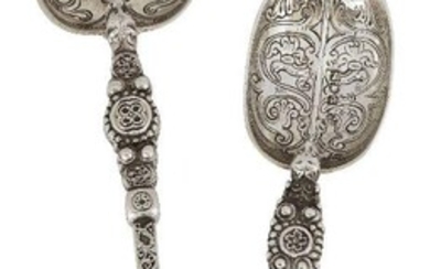 Two Edwardian silver replica anointing spoons, one London, c.1902, Edward Barnard & Sons, the second London, c.1910, Charles Boyton & Son, both designed with stylised zoomorphic heads to stems, the bowls chased with scroll and foliate motifs, the...