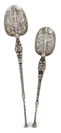 Two Edwardian silver replica anointing spoons, one London, c.1902, Edward Barnard & Sons, the second London, c.1910, Charles Boyton & Son, both designed with stylised zoomorphic heads to stems, the bowls chased with scroll and foliate motifs, the...