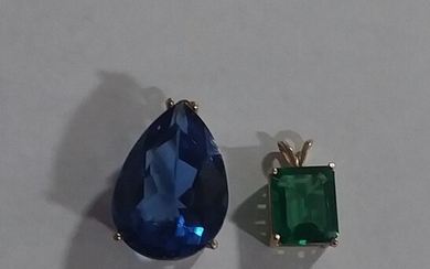 Two pendants one emerald colored one blue topaz colored