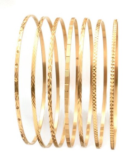 WEEKLY BRACELETS composed of seven yellow gold bracelets, each worked with geometric designs. Gross weight: 32.06 gr. Seven yellow gold bracelets