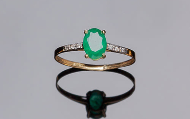 Yellow gold ring with a fine, oval emerald center,...