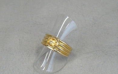 A gold eagle ring with a citrine in a closed...