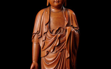 A rare carved boxwood figure of the Buddha
