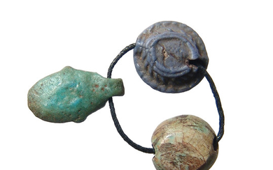 A trio of Egyptian amulets strung together