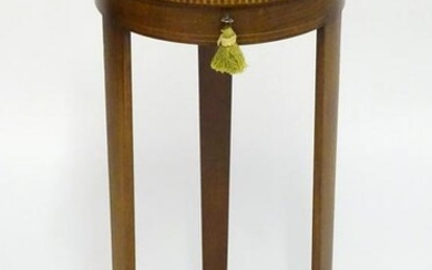 A 19thC bijouterie cabinet with a circular glass top