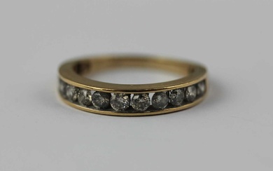 A 9ct gold and diamond eleven stone half eternity ring