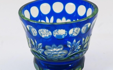 A Bohemian green and blue cut glass vase, 20th century, of squat goblet form with panelling and foliage motifs to the body and base, 11.8cm high, 12cm diameter