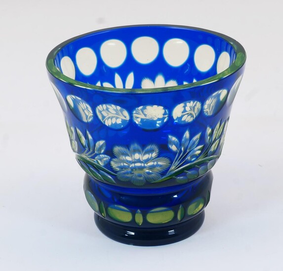 A Bohemian green and blue cut glass vase, 20th century, of squat goblet form with panelling and foliage motifs to the body and base, 11.8cm high, 12cm diameter