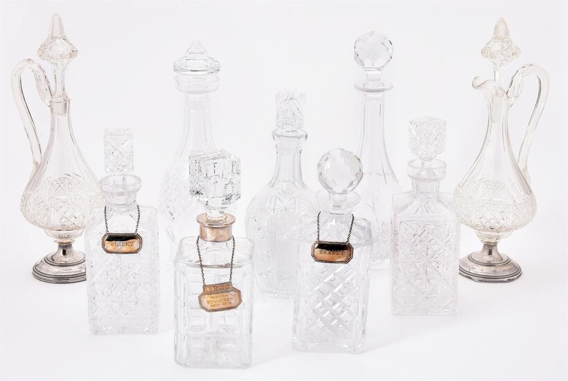 A COLLECTION OF NINE CUT GLASS DECANTERS