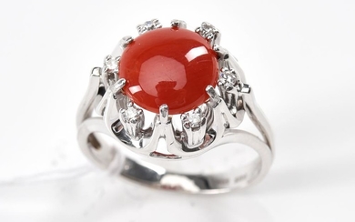 A CORAL AND DIAMOND RING-The round coral cut en cabochon, within a surround of six small round brilliant cut diamonds, in 18ct white...